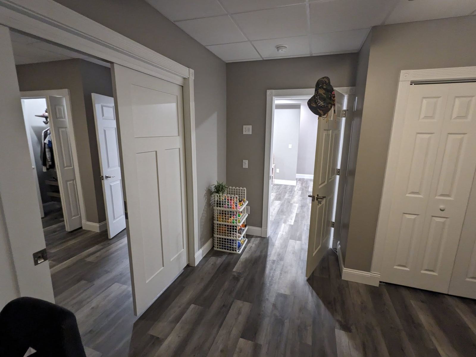 Finished basement hallway gray flooring Davenport IA